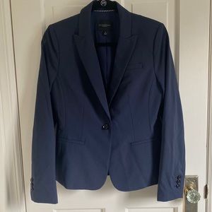 Navy classic skirt suit. One button jacket. Side slit on skirt.